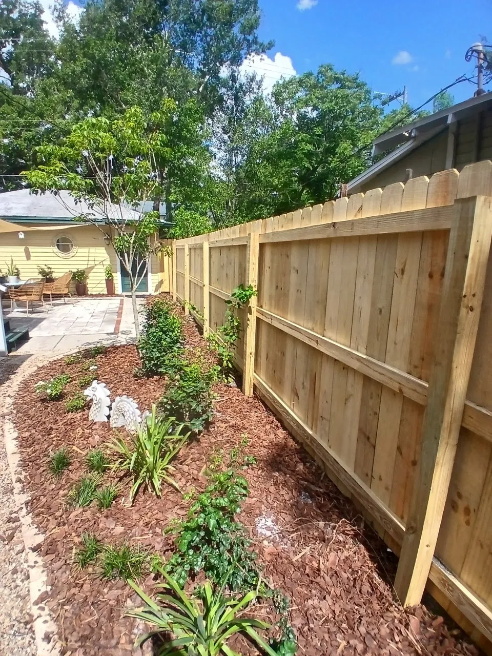 wood stockade fence installed by top rail fence