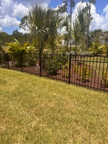 three rail ornamental metal fence installed by top rail fence