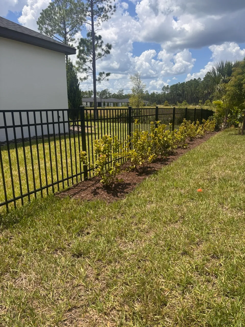 three rail ornamental metal fence installed by top rail fence