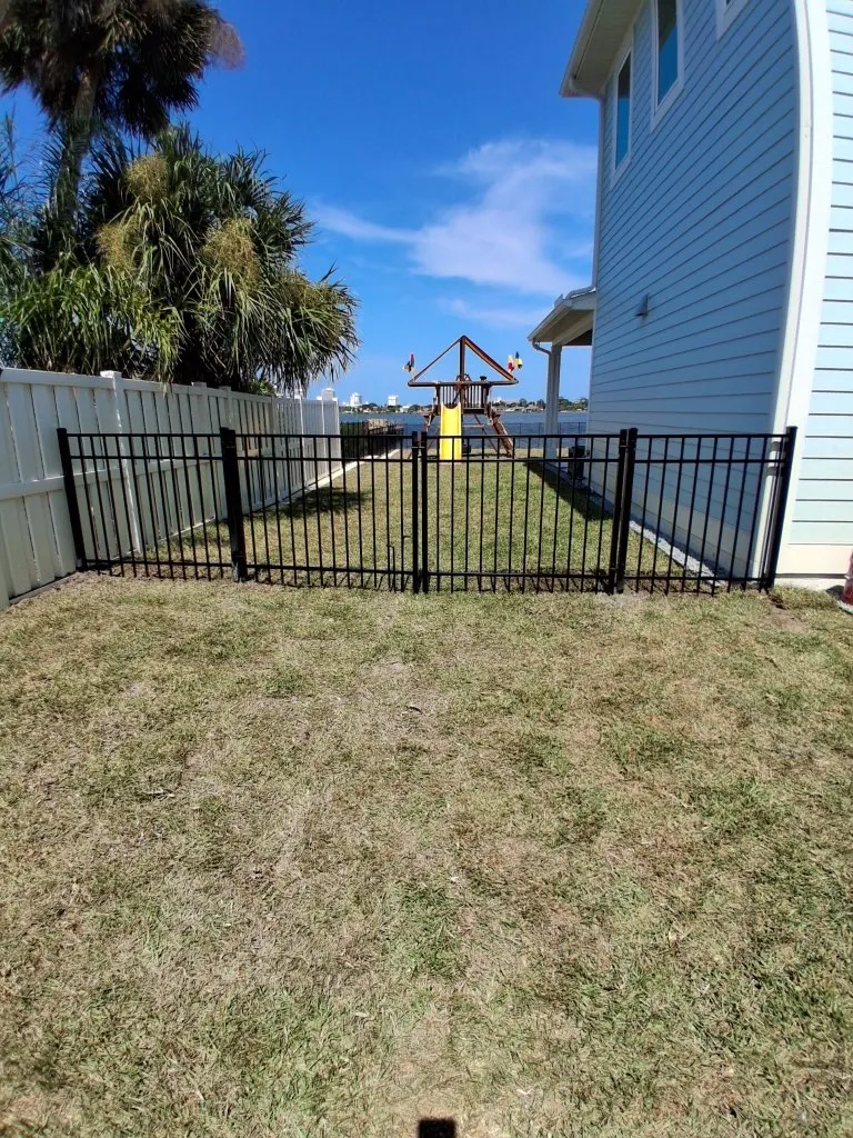 three rail ornamental metal fence installed by top rail fence