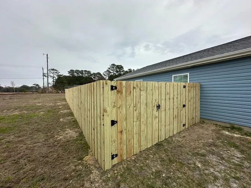 wood board on board gate installed by top rail fence