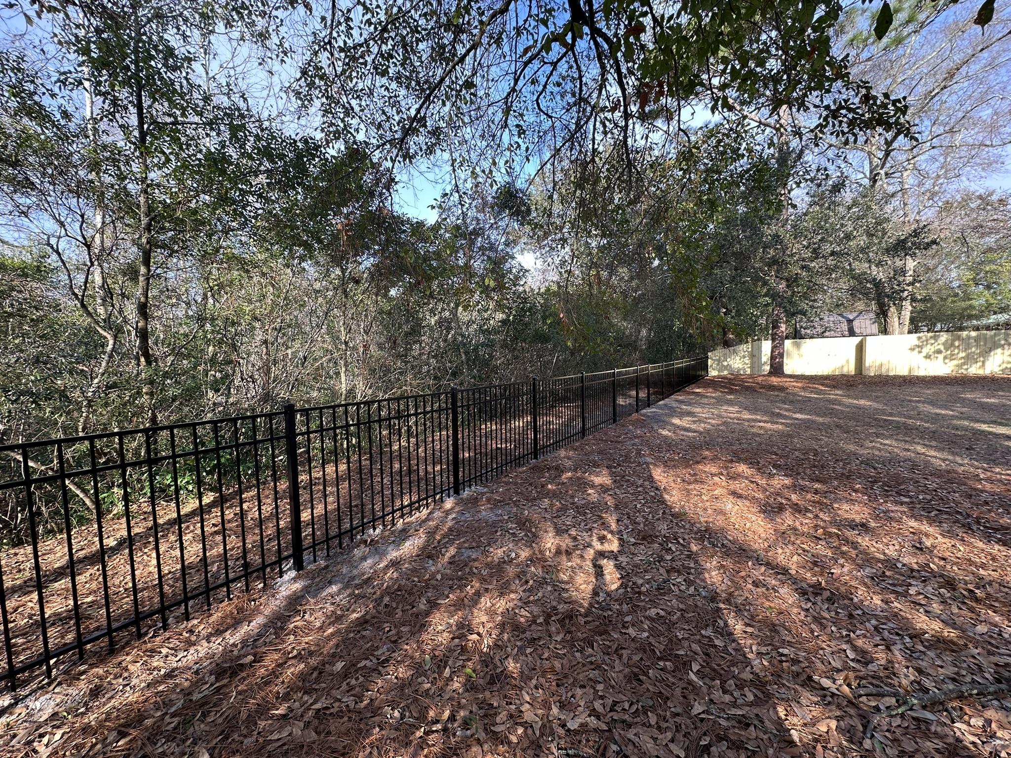 ornamental metal fence installed by top rail fence
