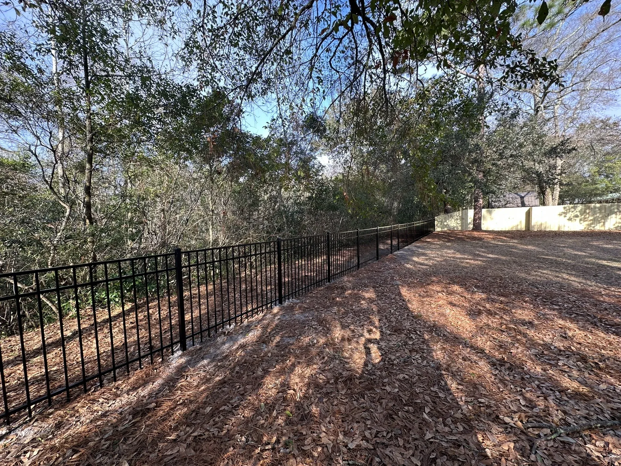 ornamental metal horizontal fence installed by top rail fence