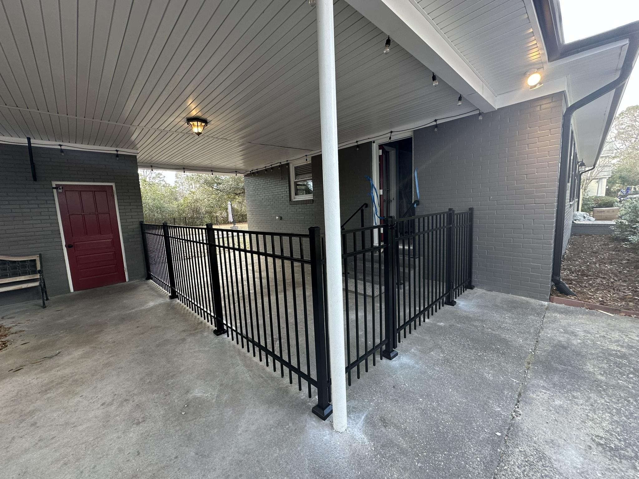 ornamental metal fence installed by top rail fence