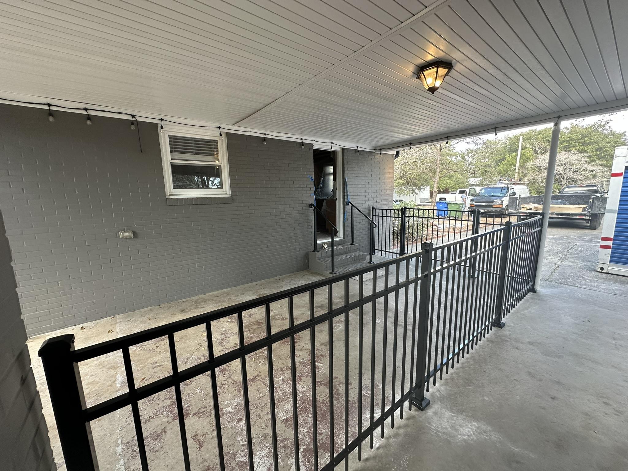 ornamental metal fence installed by top rail fence
