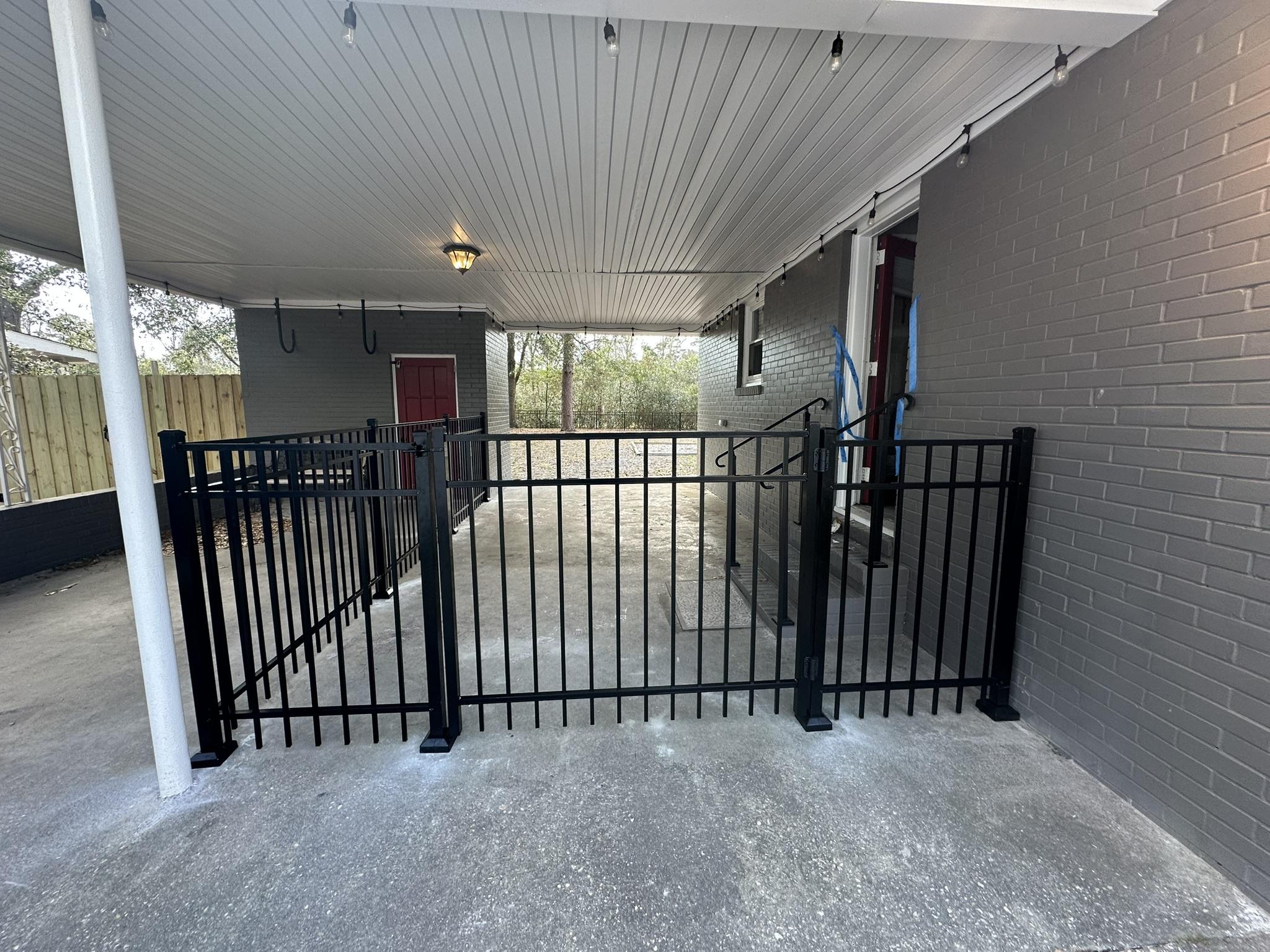 ornamental metal fence installed by top rail fence
