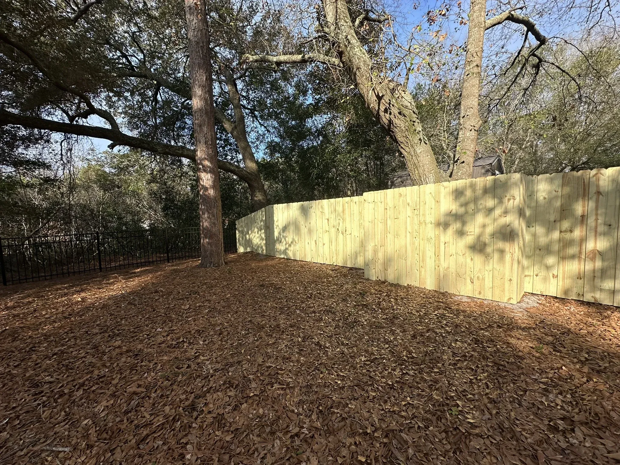 wood stockade fence installed by top rail fence