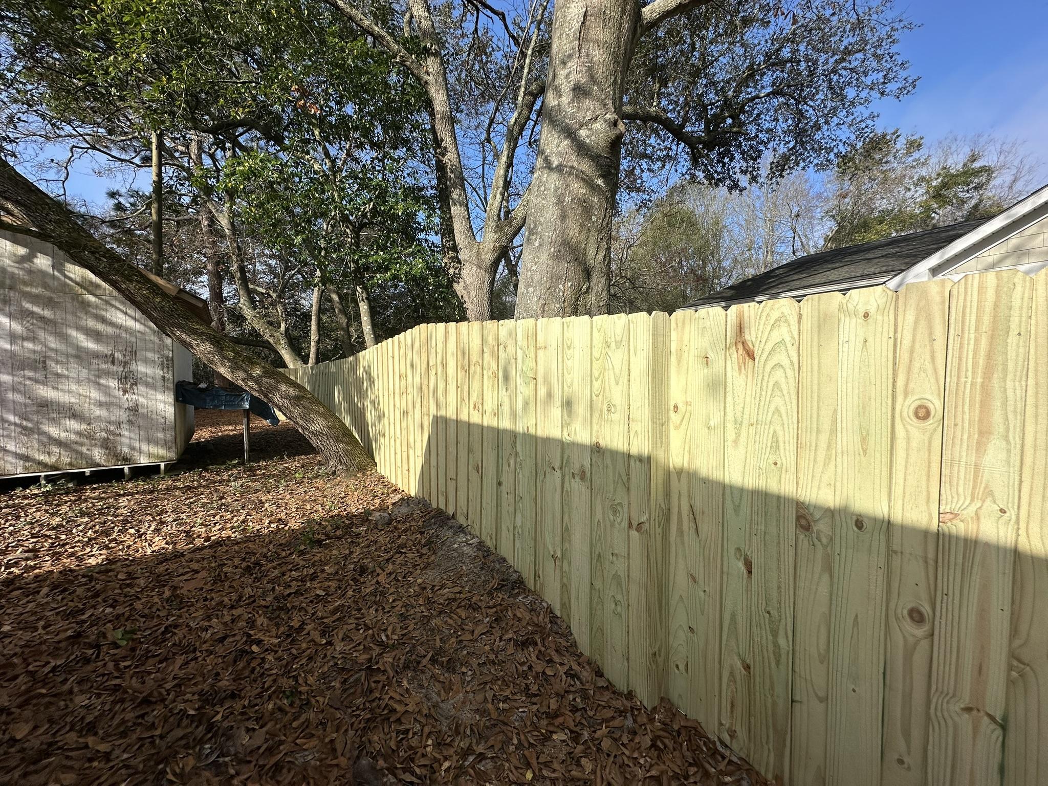 wood stockade fence installed by top rail fence