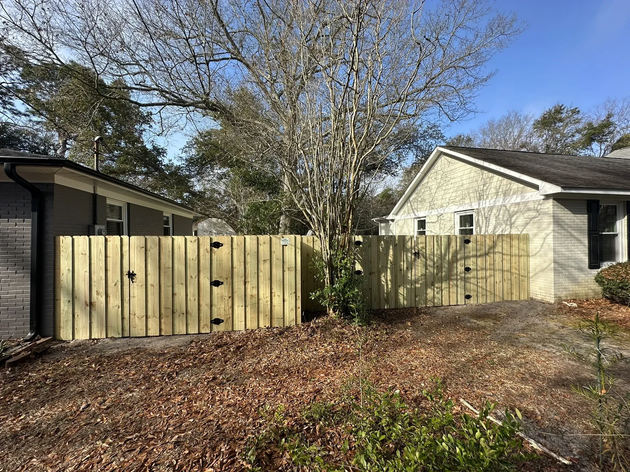 wood board on board gate installed by top rail fence