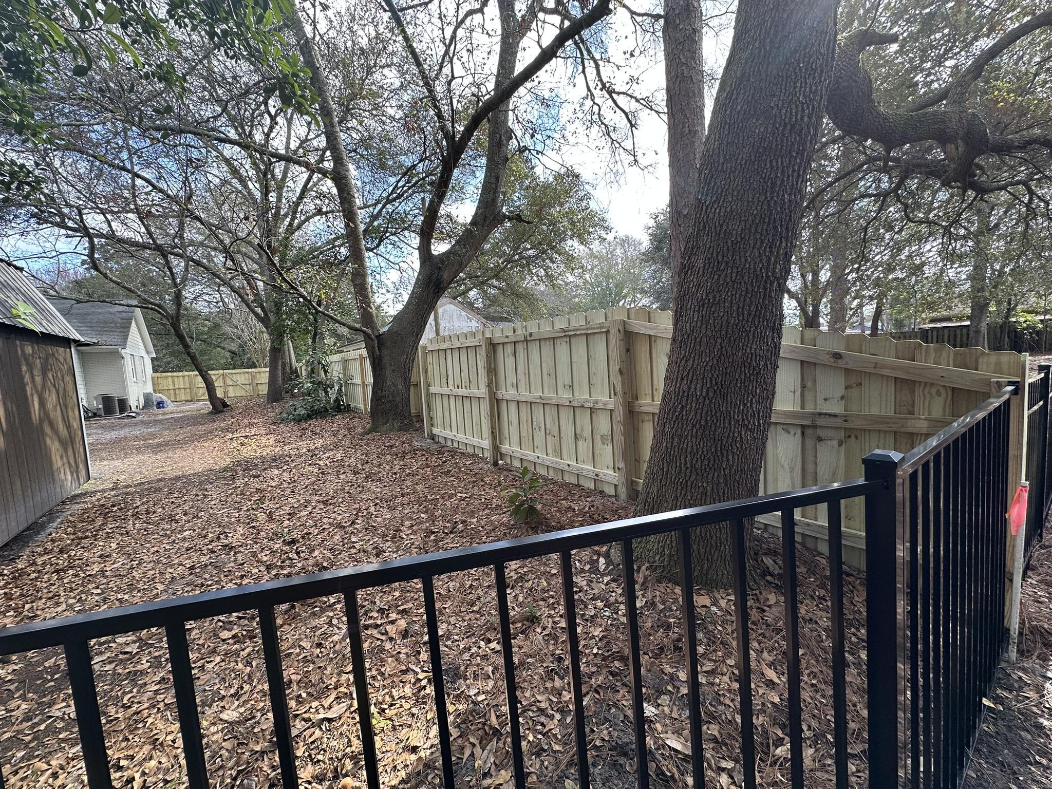 ornamental metal fence installed by top rail fence