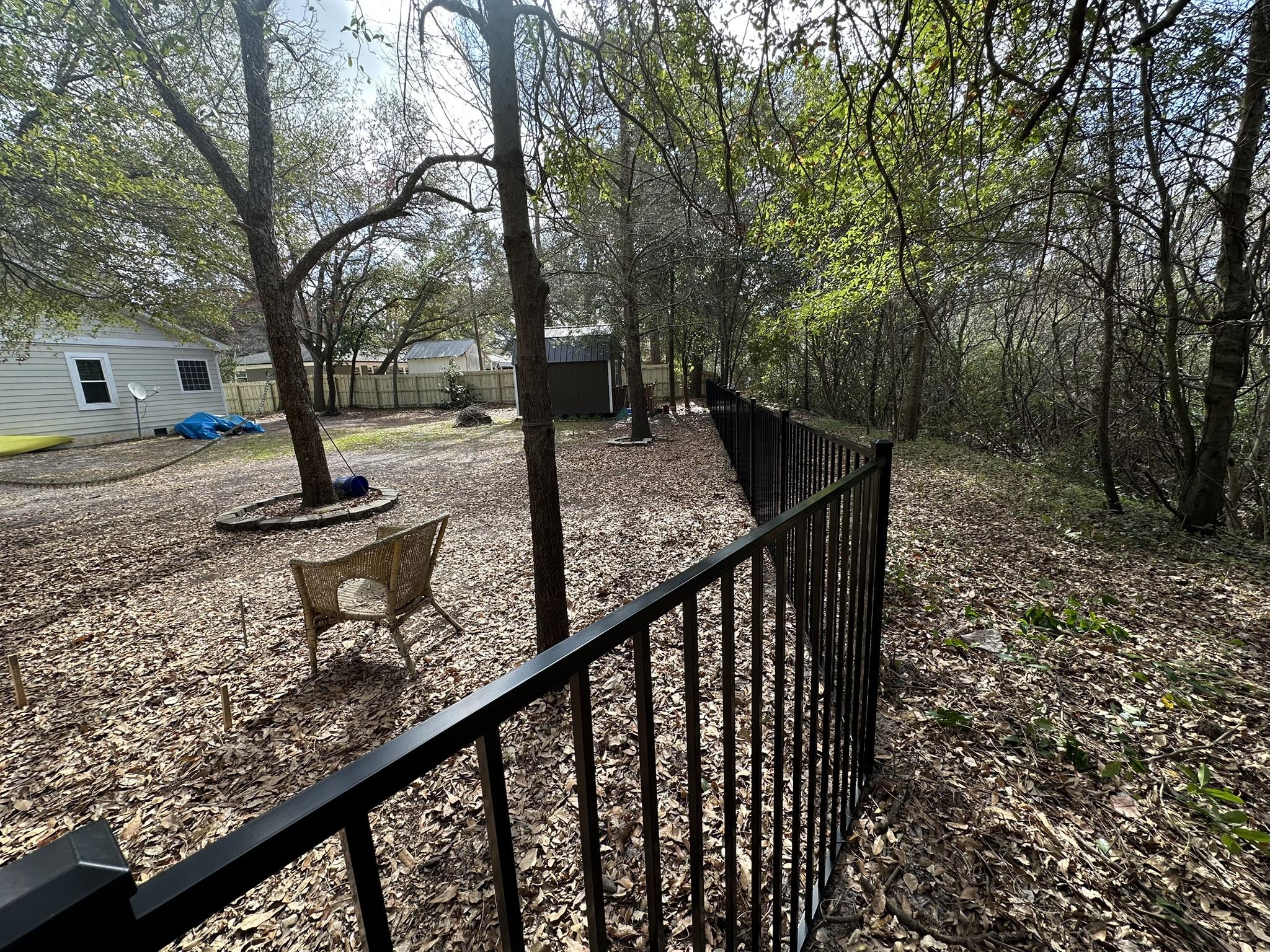 ornamental metal fence installed by top rail fence