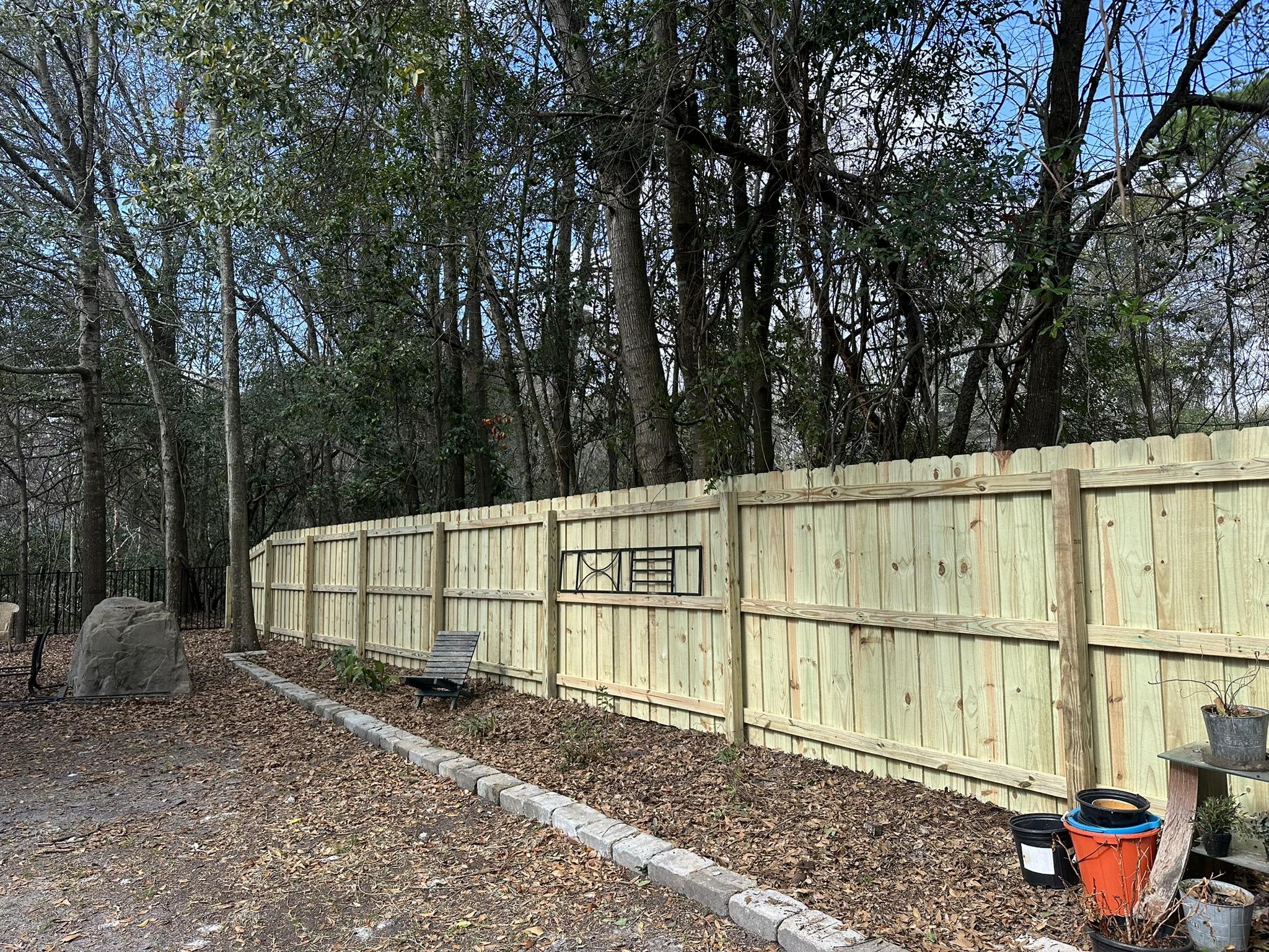 stockade wood fence installed by top rail fence