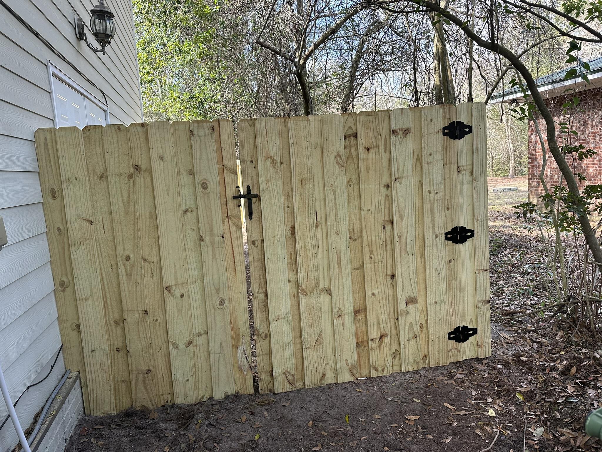 wood board on board gate installed by top rail fence