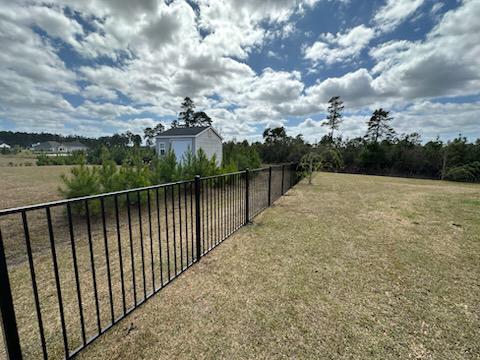 ornamental metal fence installed by top rail fence