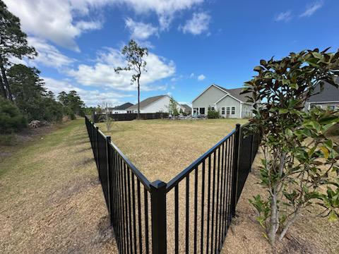 ornamental metal fence installed by top rail fence