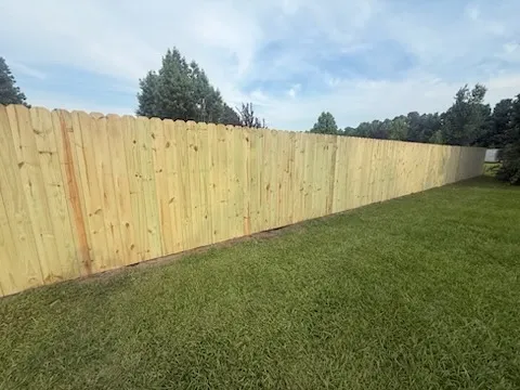 wood stockade fence installed by top rail fence