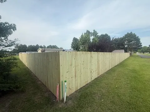 wood stockade fence installed by top rail fence