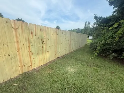 stockade fence installed by top rail fence