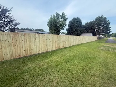 wood stockade fence installed by top rail fence