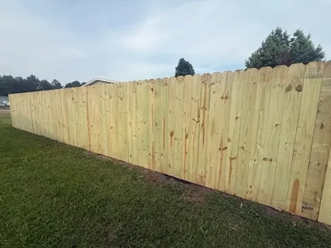 wood stockade fence installed by top rail fence