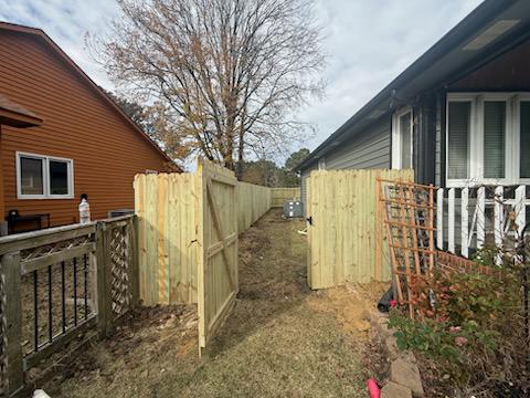 wood stockade gate installed by top rail fence