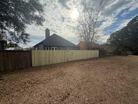 wood stockade fence installed by top rail fence