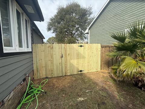 wood stockade fence installed by top rail fence