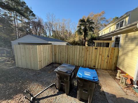 Wood stockade fence installed by top rail fence