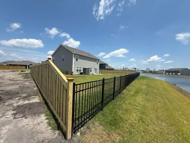 three rail ornamental metal fence installed by top rail fence
