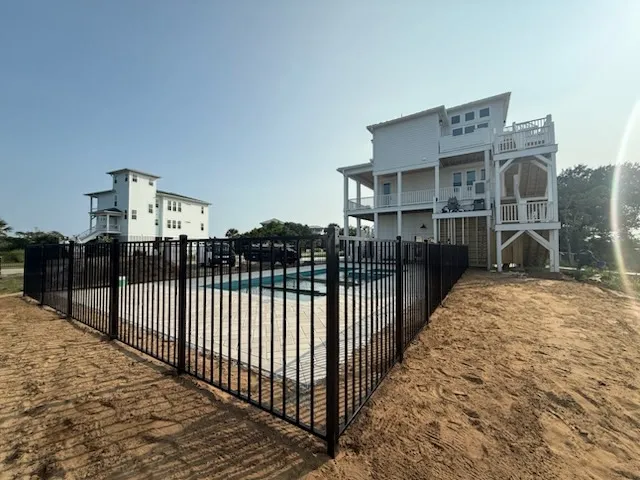 two rail ornamental metal fence installed by top rail fence