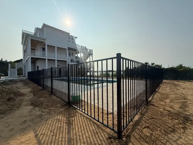 two rail ornamental metal fence installed by top rail fence