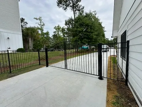 ornamental metal gate installed by top rail fence