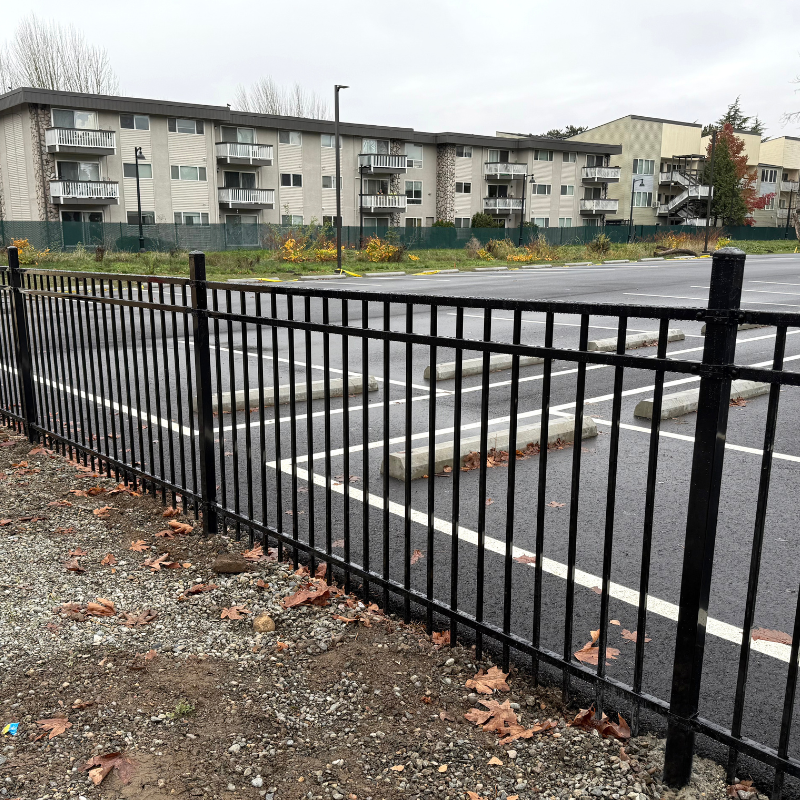 ornamental metal horizontal fence installed by top rail fence