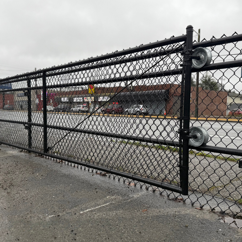 commercial black chain link fence installed by top rail fence