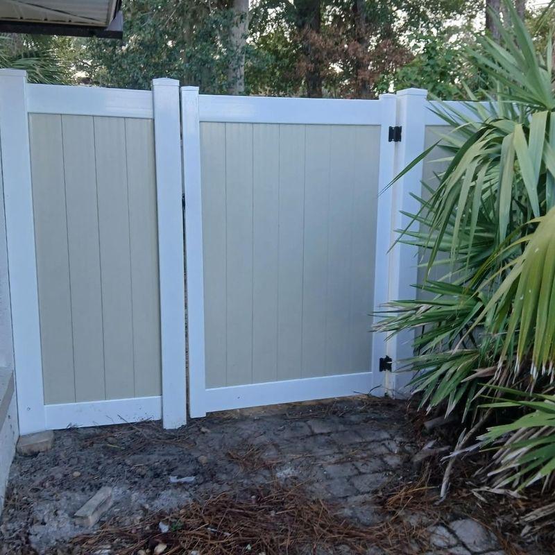 Two tone vinyl fence installed by Top Rail Fence