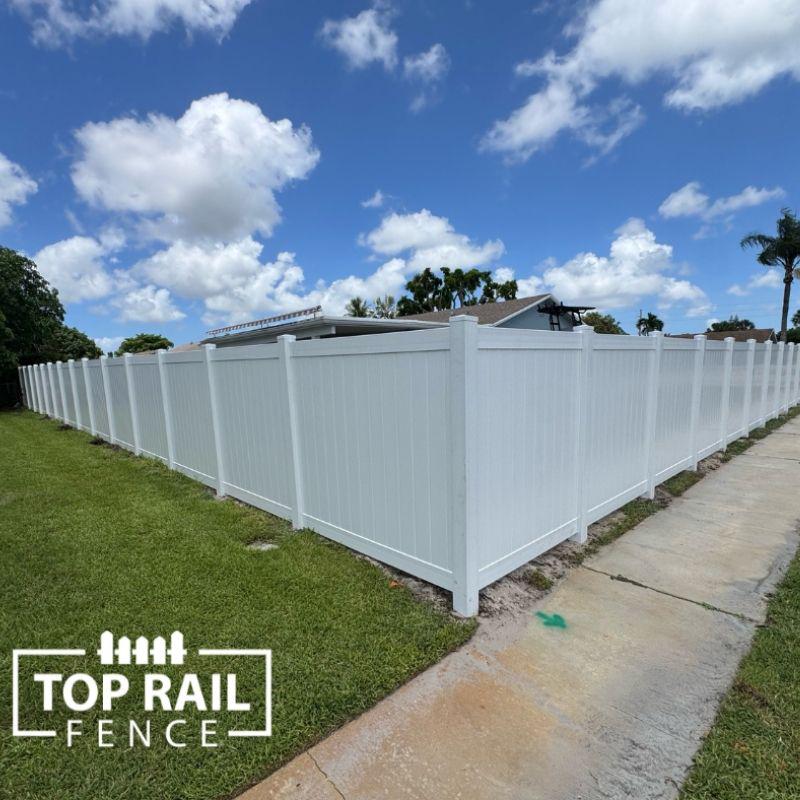 privacy vinyl fence installed by top rail fence