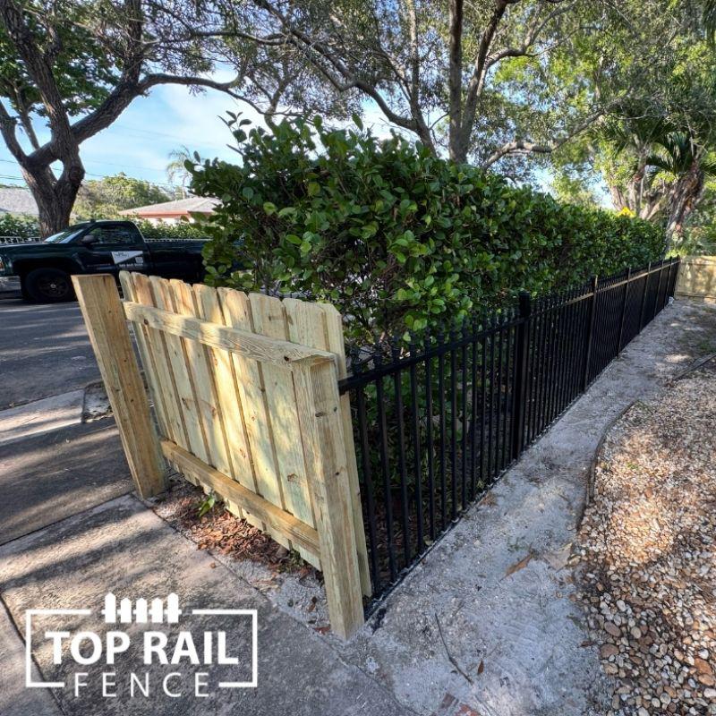 wood and aluminum fence installed by top rail fence