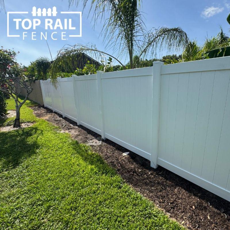 white vinyl fence installed by top rail fence