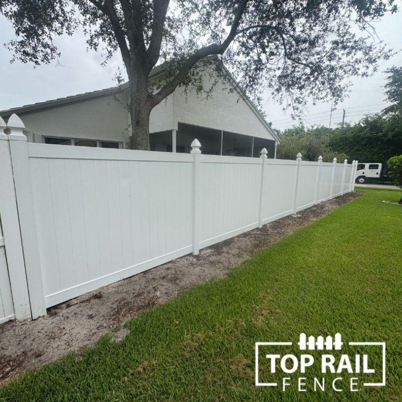 white vinyl fence installed by top rail fence