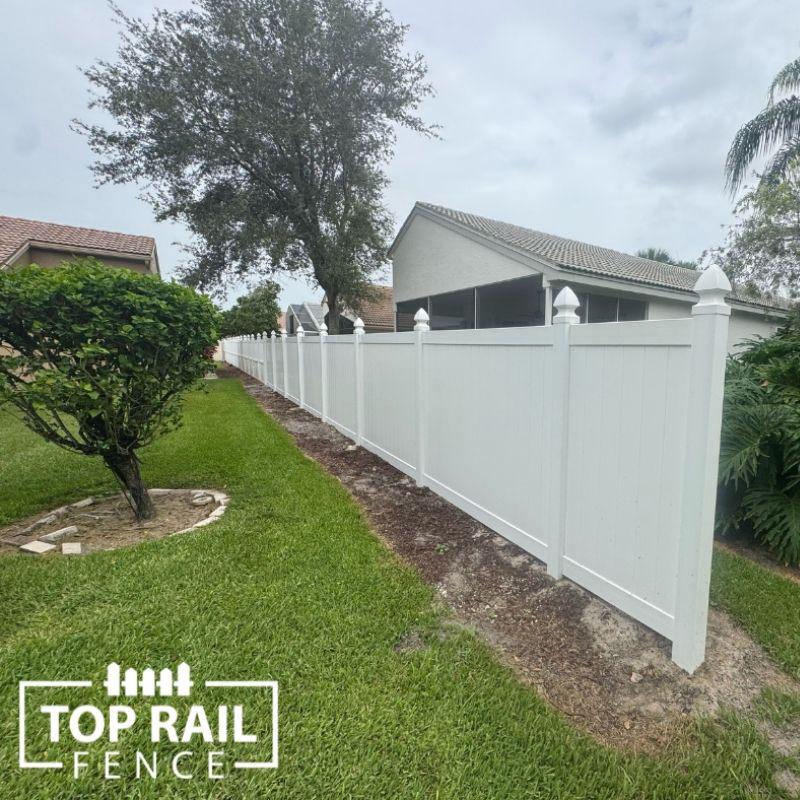 white vinyl fence installed by top rail fence