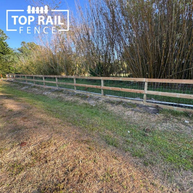 ranch rail and black chain link fence installed by Top Rail Fence