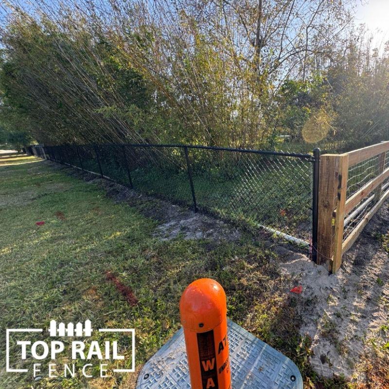 ranch rail and black chain link fence installed by Top Rail Fence