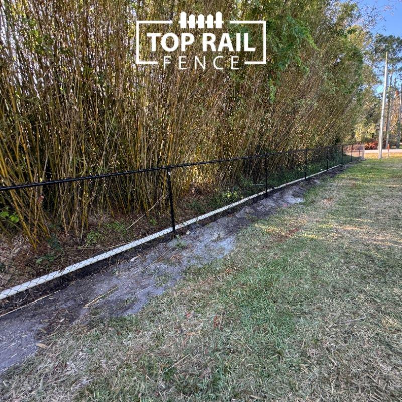ranch rail and black chain link fence installed by Top Rail Fence