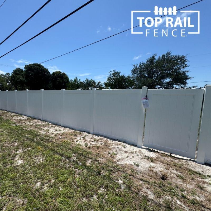 white privacy vinyl fence installed by Top Rail Fence