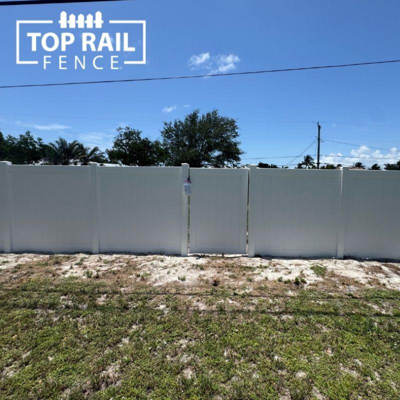 white privacy vinyl fence installed by Top Rail Fence