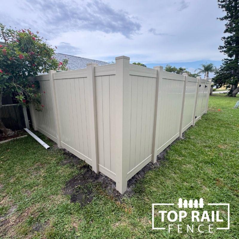 tan privacy vinyl fence installed by Top Rail Fence