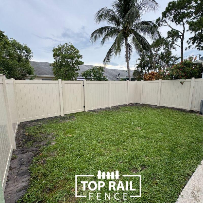 tan privacy vinyl fence installed by Top Rail Fence