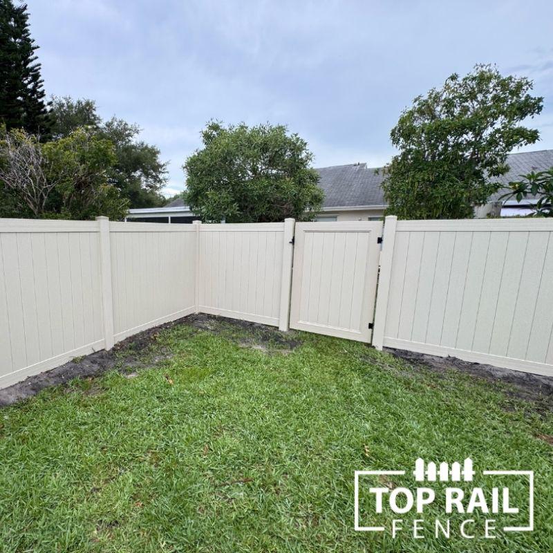 tan privacy vinyl fence installed by Top Rail Fence