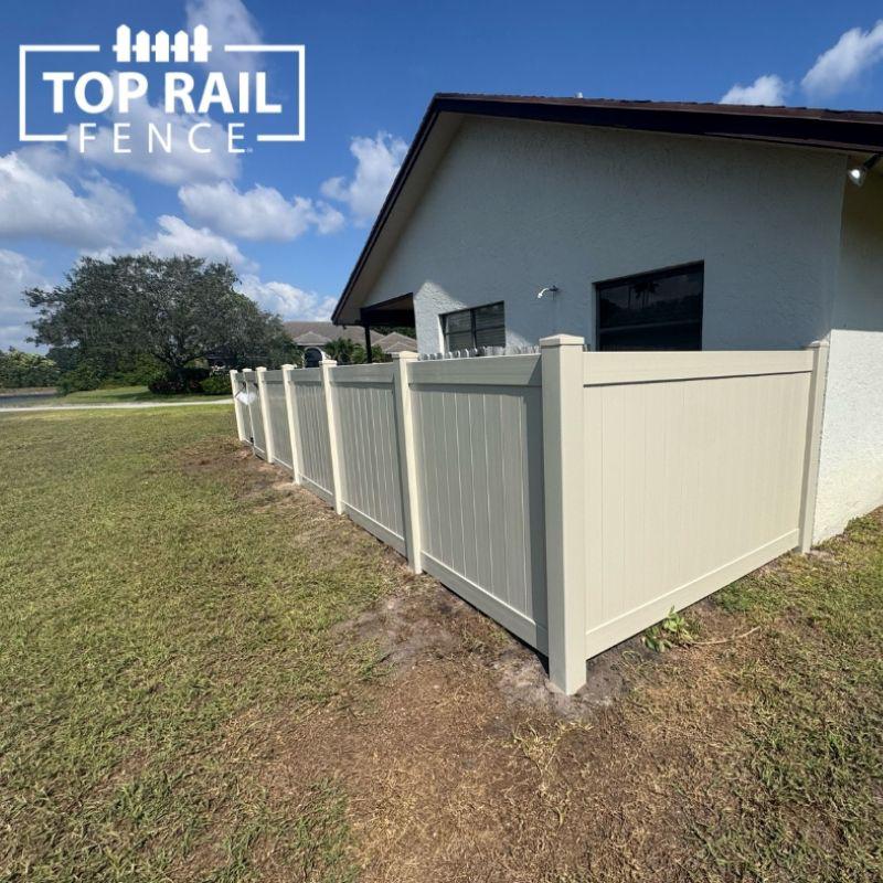tan privacy fence installed by Top Rail Fence