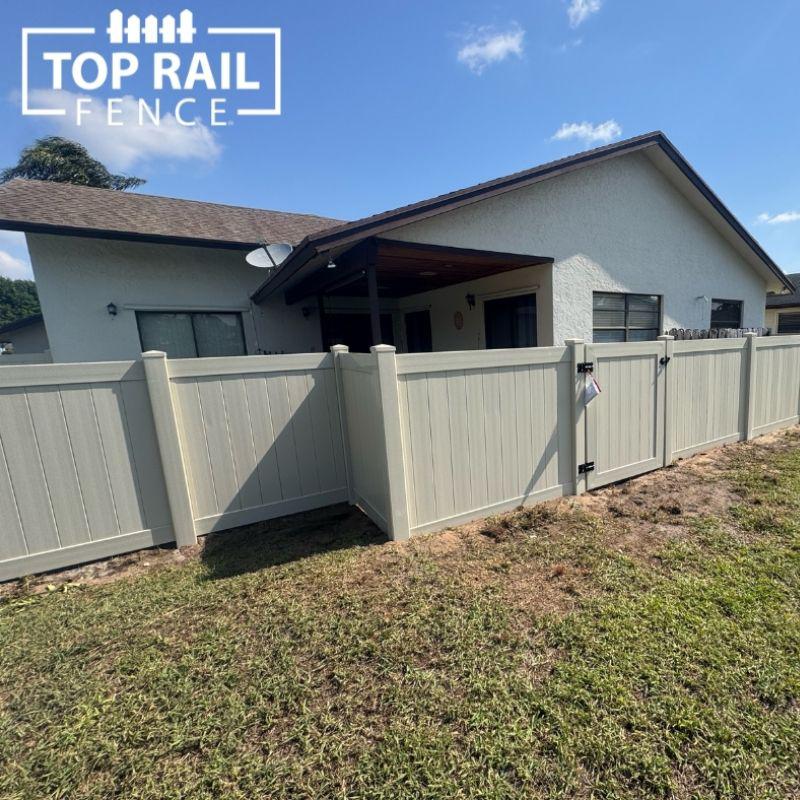tan privacy fence installed by Top Rail Fence